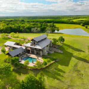 A large house with a pool in the middle of it