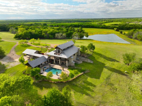 A large house with a pool in the middle of it